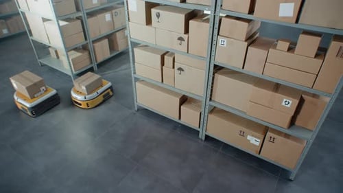 Automated Guided Vehicles Transporting Cardboard Boxes in Modern Retail Warehouse