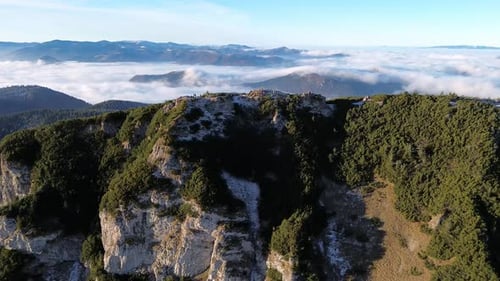 Aerial View of Mountainous Landscape with Forests Valley Full of Fog