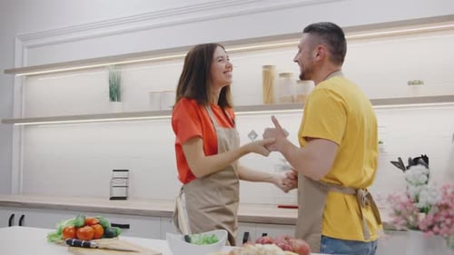 Happy Couple Dancing in Kitchen