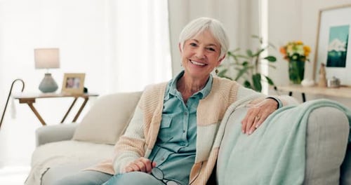 Happy, senior woman and relax on sofa in nursing home or grandma with happiness