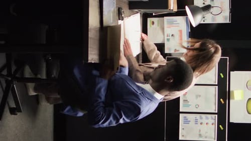 Office Workers Consult Over Financial Charts