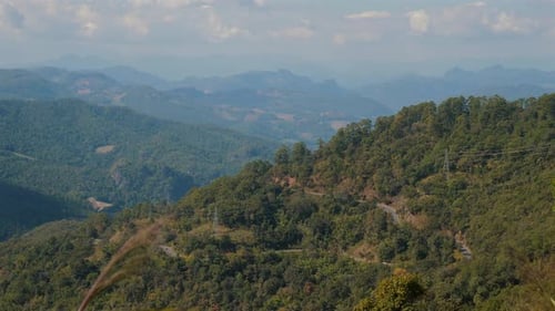 Expansive View of Lush Green Mountains Under Blue Skies