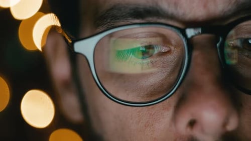 Man Wearing Glasses with Screen Reflection Close Up