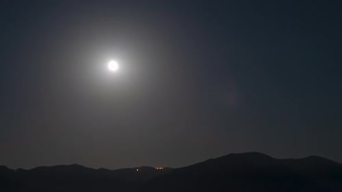Moon view over the mountain at night time lapse 4K
