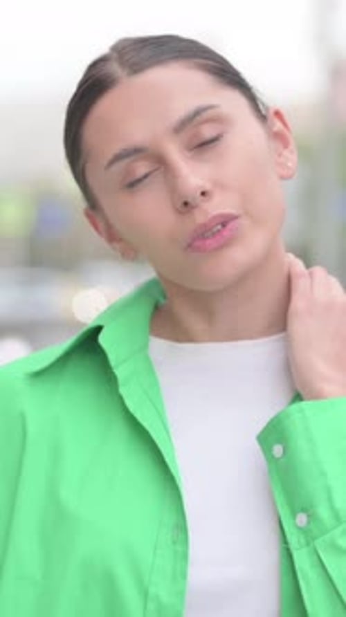 Woman Massaging Neck for Relief of Pain