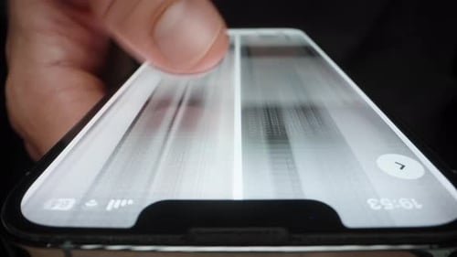 A Man in his Phone Quickly Flips Through Pictures, A Blurry Image. Macro frame