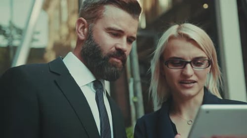 Professional Consultants and Executives Focus on Investment Review During Outdoor Meeting in City