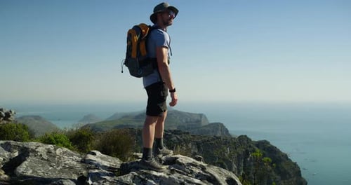 Man, trekking in nature and mountain top for travel adventure, hiking and fitness