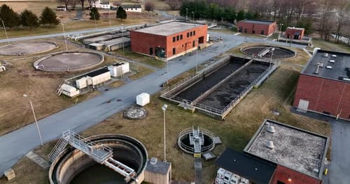 Water treatment facility plant. Aerial of wastewater sewage plant. Flight over holding tanks for pur
