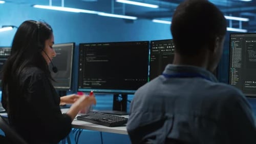 IT Support Worker in Remote Call Using Headset Microphone in Data Center