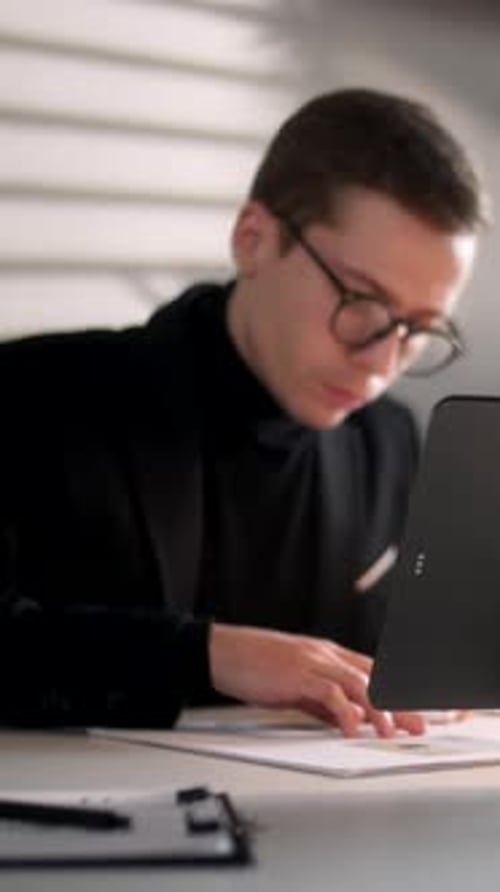Young Adult Working at Desk in Modern Office