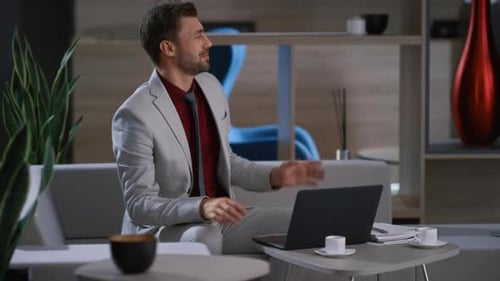 Man and Woman Collaborating on Laptop in Office