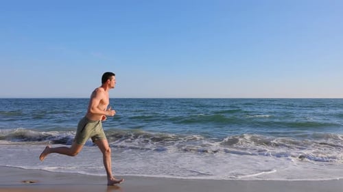 Athletic Man Exercising At The Beach