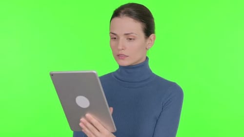 Beautiful Woman using Digital Tablet on Green Background