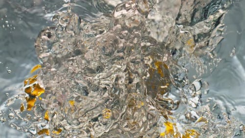 Oranges Plunging into Clear Water Tank