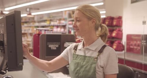 Portrait of Mature Female Supermarket Cashier Looking at Camera in Store