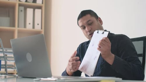 Man Presenting Business Data in Online Meeting