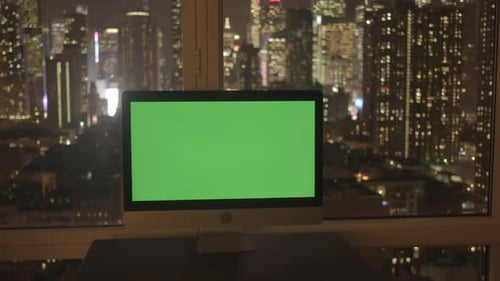 Desktop Computer with Green Screen City Night Background