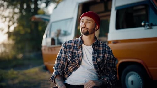 Bearded Man Relaxing By a Camper Van