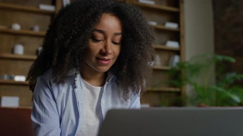 Young Woman Working on Laptop at Home