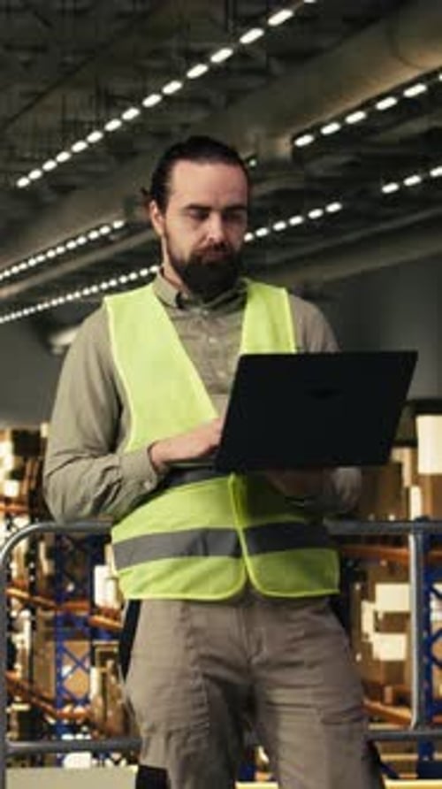 Vertical Video Logistics Staff Working in Warehouse with Laptop for Distribution and Shipment