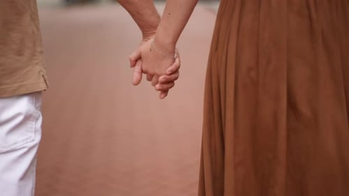 Close Up of Romantic Couple Holding Hands Walking