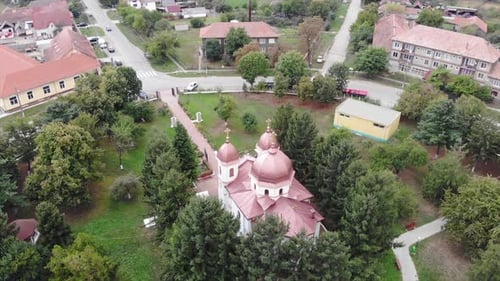 Drone Aerial over orthodox church in Romania sunny countryside