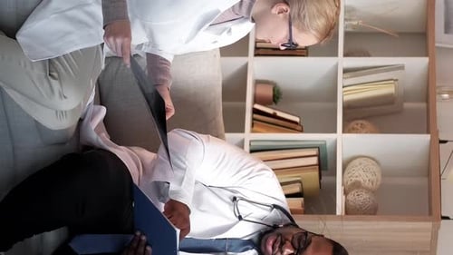 Doctors Reviewing Patient X-Ray in Office Setting