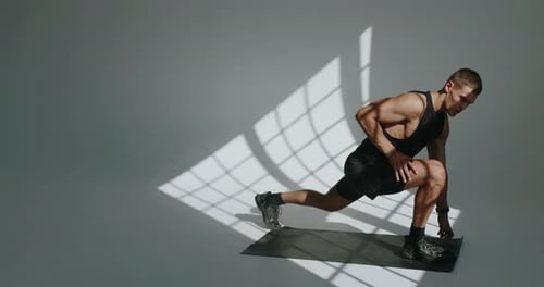 Man Doing Static Stretching on Yoga Mat