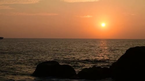 Beautiful evening sunset in Galle fort beach timelapse full HD clip. silhouette rocks in the foregro