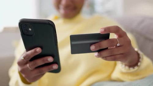 Woman Uses Phone and Credit Card at Home