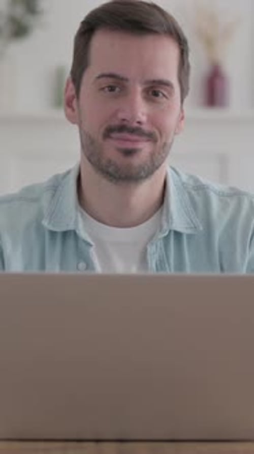 Man with Beard Looks at Camera in Home Setting