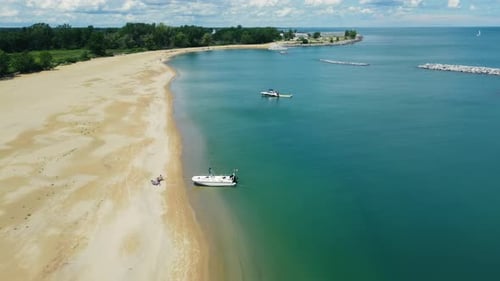 Aerial View of a Sandy Beach with Boats Near the Shore A Serene Aerial View of a Sandy Beach with