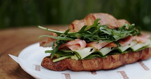Close Up of a Sandwich on a Plate Showcasing Staple Food on Tableware