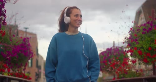 Attractive Young Woman Listening to Music in Headphone at City Walk Smile Portrait Close Up Slow