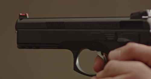 Close up of 9mm handgun barrel while being fired