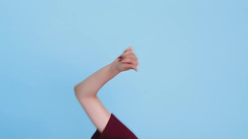 Young Woman with Pink Hair Gives Thumbs Down