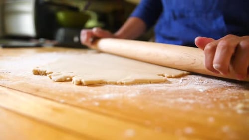 Dough Rolled Out on Wooden Kitchen Surface