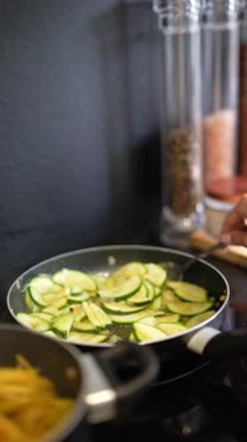 Preparing Zucchini and Noodles in a Pan