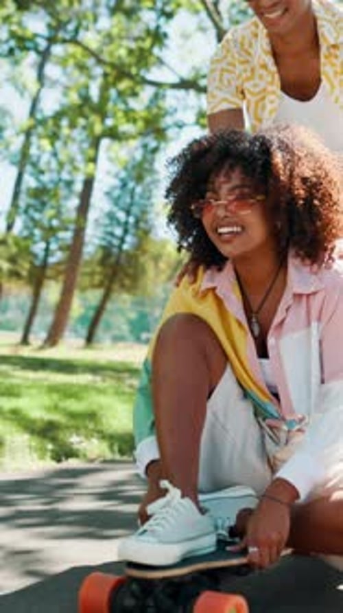 Happy, couple and push on skateboard at park with freedom, bonding activity or street style