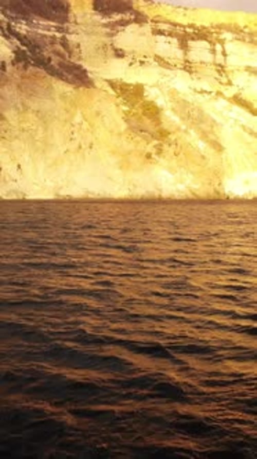 Sea Water Surface at Sunset Vertical Aerial View Camera Flies Over Calm Golden Sea Sun Glare