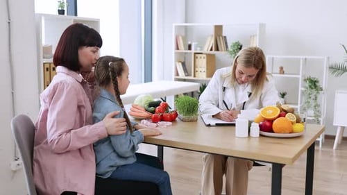 Doctor Talking to Mother and Child About Nutrition