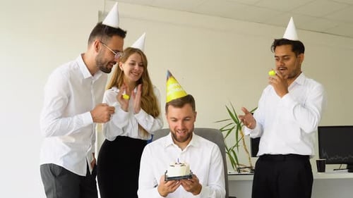 Young Office Worker is Blow Candles on Cake and Make a Wish While Celebrating Birthday with