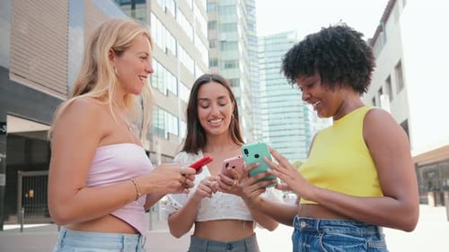 Friends Using Smartphones in the City