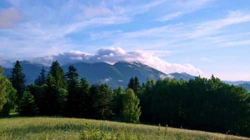 Clouds pour over the mountains in the Carpathian mountain landscape in summer