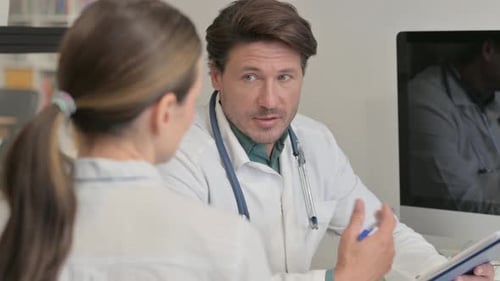 Close Up of Doctor Discussing Medical Report with Female Patient