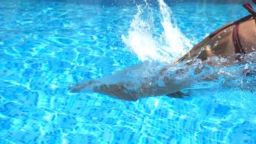 Young Unrecognizable Woman Jumping in Pool and Splashing Crystal Clear Water Attractive Girl in