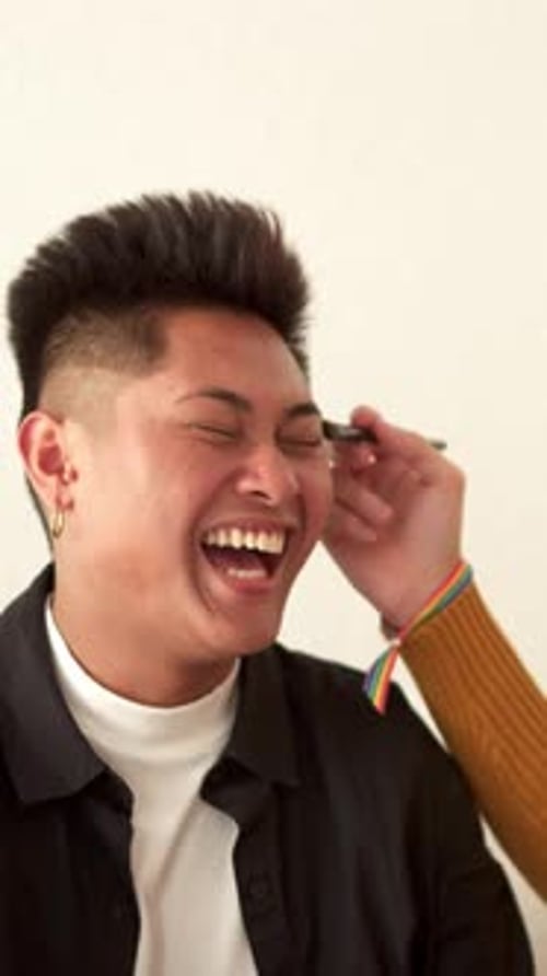 Young Adult Smiling During Makeup Application