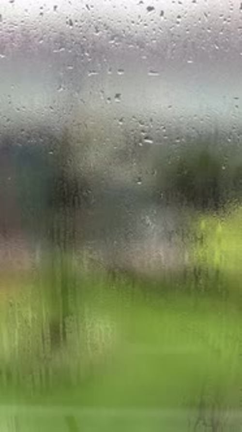 Rain drop on window over blurred nature background, Portrait