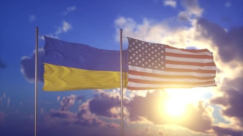 Ukrainian and American Flags Waving in Golden Sunset Sky